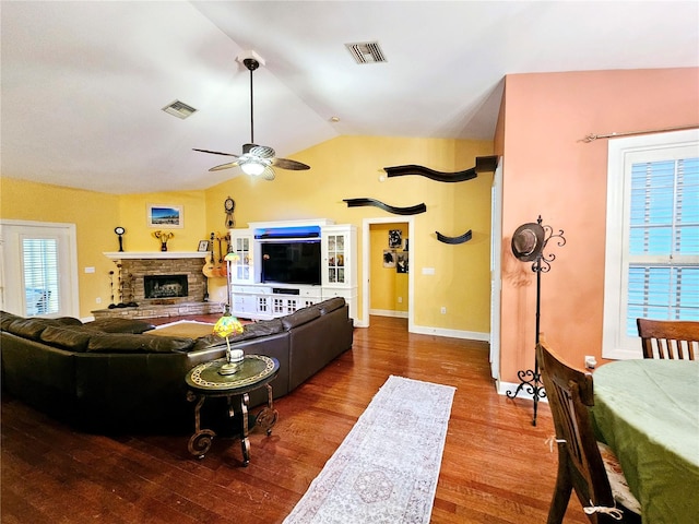 living room with ceiling fan, hardwood / wood-style floors, and vaulted ceiling