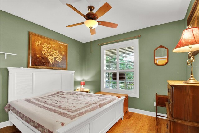 bedroom with wood-type flooring and ceiling fan