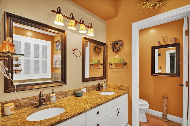 bathroom featuring tile patterned flooring, toilet, and vanity