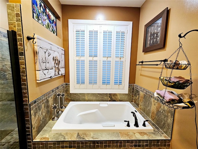 bathroom with a relaxing tiled tub