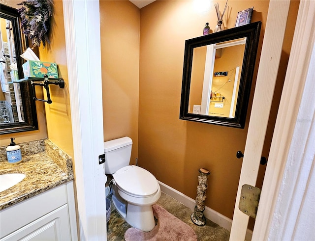 bathroom featuring toilet and vanity