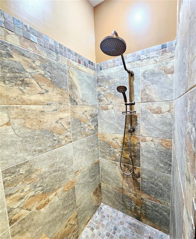 interior details with a tile shower