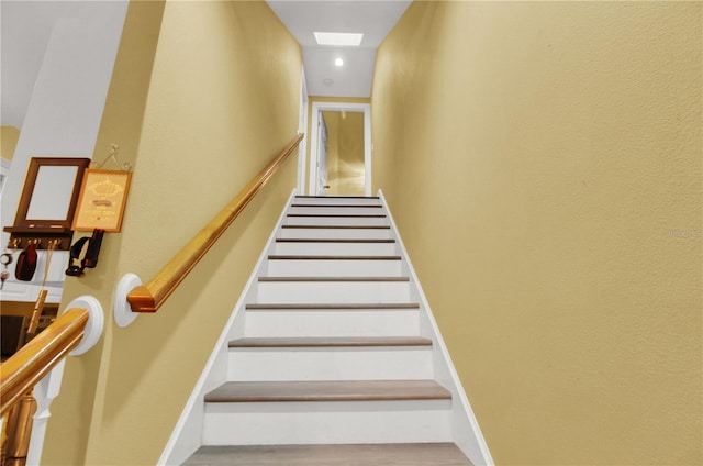 stairs featuring wood-type flooring