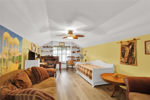 living room featuring lofted ceiling, ceiling fan, and light hardwood / wood-style floors