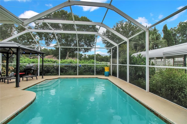 view of pool featuring a patio and glass enclosure