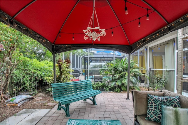 view of patio with glass enclosure and a gazebo