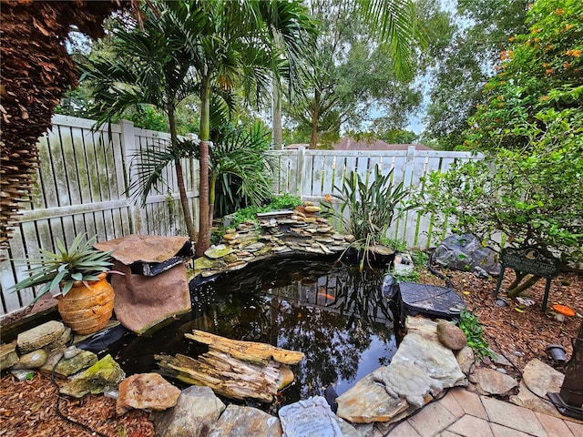 view of yard with a small pond