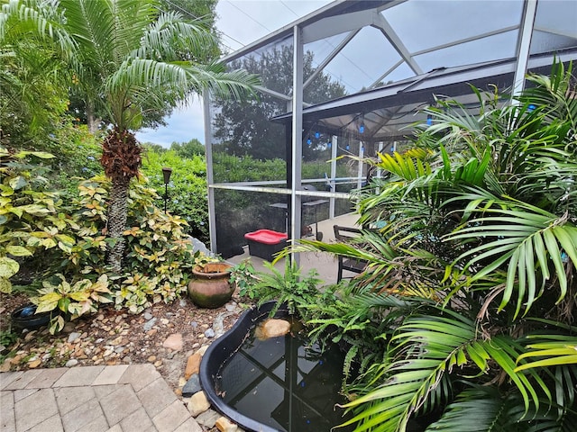 view of patio / terrace featuring a lanai