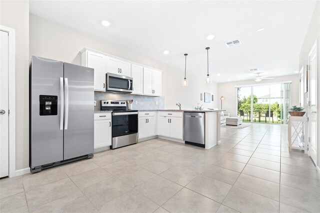 kitchen featuring appliances with stainless steel finishes, hanging light fixtures, kitchen peninsula, white cabinetry, and ceiling fan