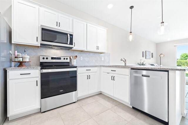 kitchen with white cabinetry, kitchen peninsula, stainless steel appliances, and sink