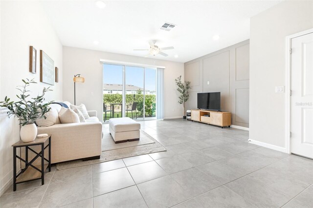 living room featuring ceiling fan and light tile patterned floors