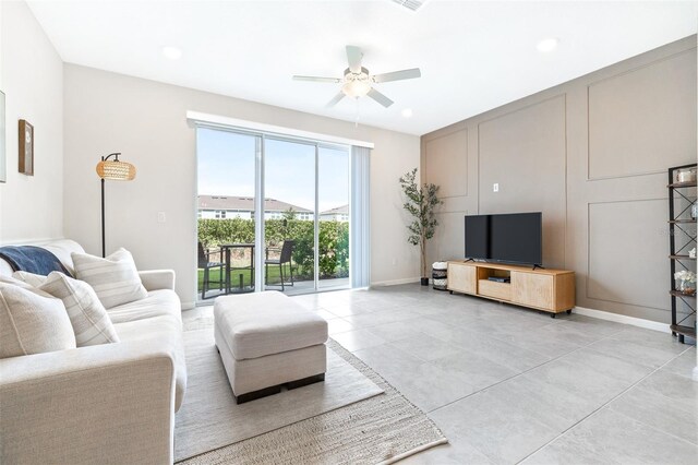 living room with ceiling fan and a wealth of natural light