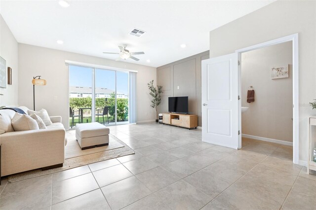 living room with ceiling fan and light tile patterned flooring