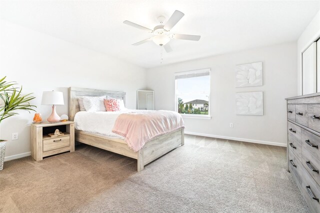 bedroom featuring light colored carpet and ceiling fan