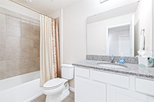 full bathroom with tile patterned flooring, shower / bathtub combination with curtain, toilet, vanity, and a textured ceiling