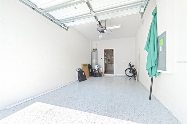 garage with water heater, a garage door opener, and electric panel