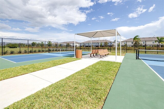 view of sport court with a yard