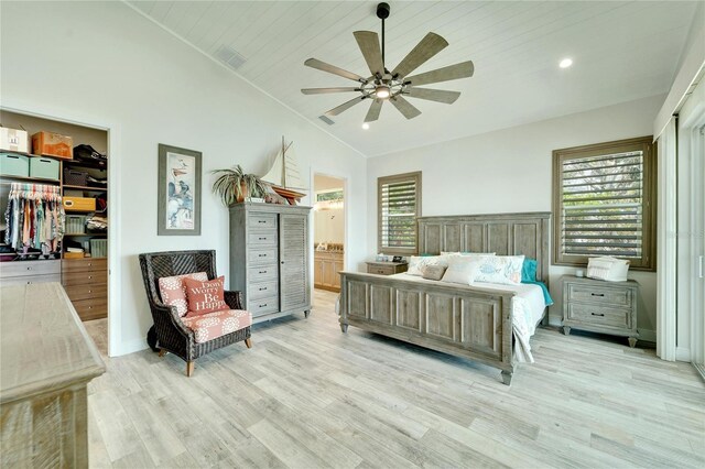 bedroom featuring ensuite bath, light wood-type flooring, wood ceiling, lofted ceiling, and ceiling fan