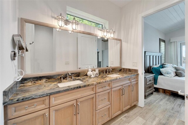 bathroom featuring lofted ceiling, vanity, and hardwood / wood-style flooring