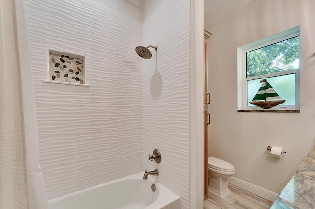 bathroom featuring shower / bath combo, baseboards, toilet, and wood finished floors