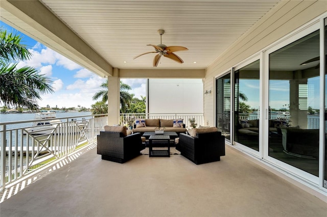 view of patio / terrace featuring a water view, an outdoor living space, and ceiling fan