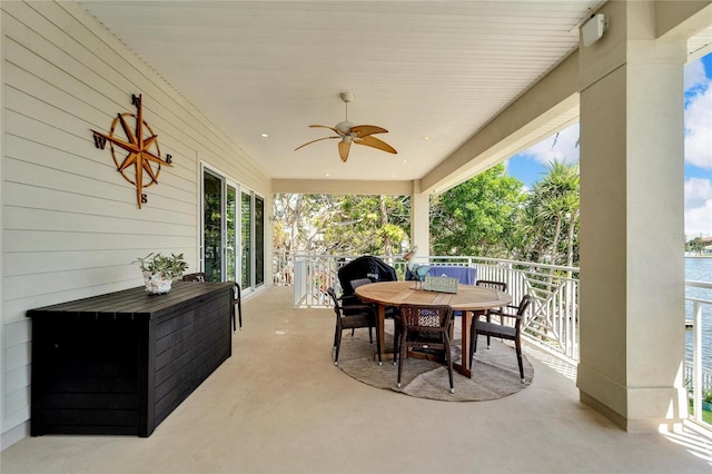 view of patio with ceiling fan and a water view