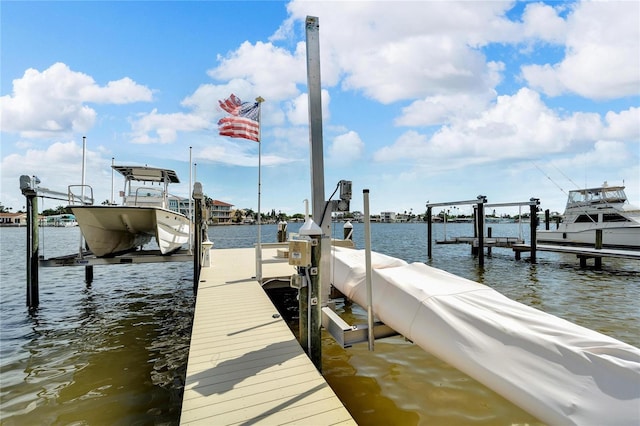 dock area with a water view and boat lift