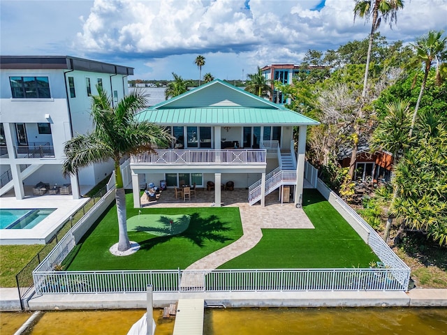 rear view of property with a patio, a yard, a water view, and a fenced backyard