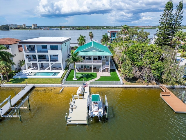 dock area with a water view and a balcony