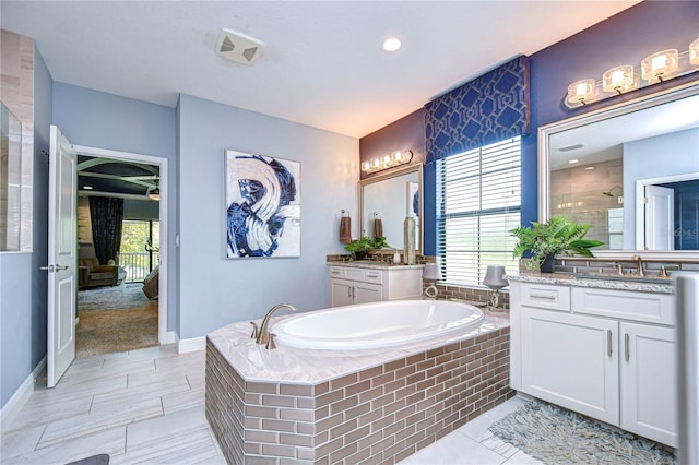 bathroom featuring vanity, plenty of natural light, and shower with separate bathtub