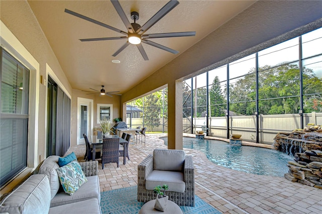 exterior space with ceiling fan and a pool