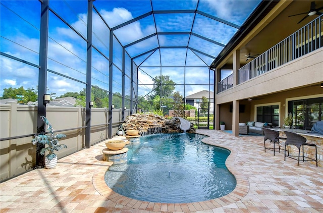 view of swimming pool with an outdoor living space, a patio area, ceiling fan, and pool water feature