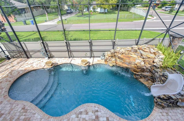 view of pool with a yard and pool water feature