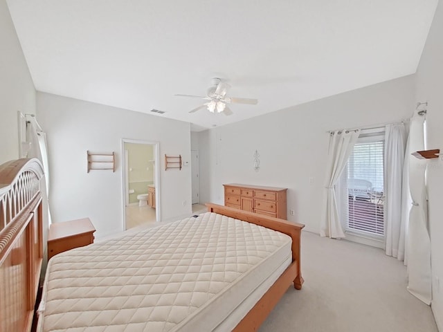 bedroom featuring visible vents, ceiling fan, ensuite bathroom, light carpet, and access to outside