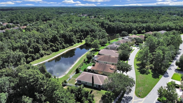 bird's eye view featuring a wooded view and a water view