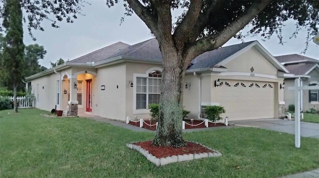 view of front facade with a garage and a front lawn