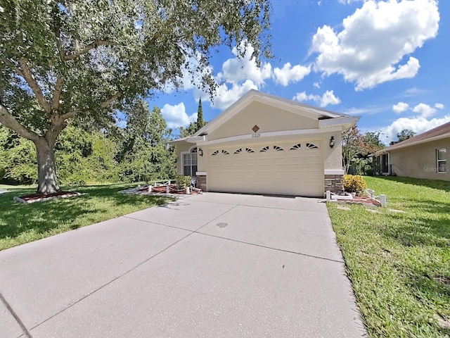 ranch-style house with stucco siding, stone siding, concrete driveway, an attached garage, and a front yard