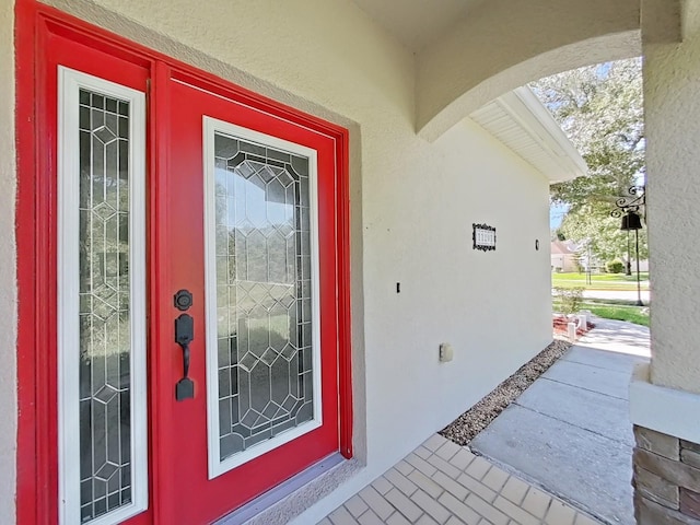 doorway to property with stucco siding