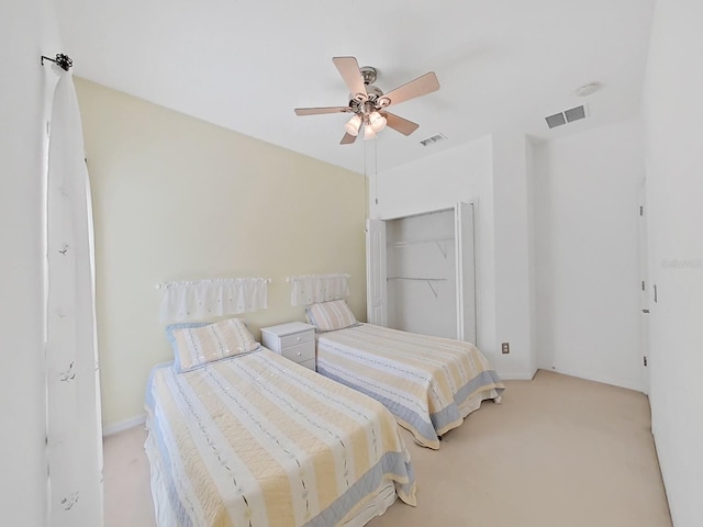 bedroom with a ceiling fan, light colored carpet, and visible vents