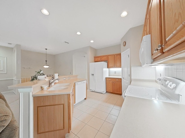 kitchen featuring white appliances, light tile patterned floors, a center island with sink, a sink, and decorative backsplash