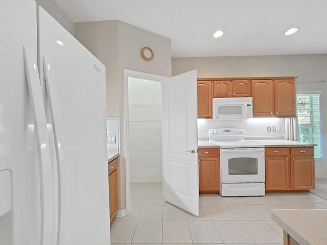 kitchen featuring light tile patterned floors, white appliances, backsplash, and light countertops