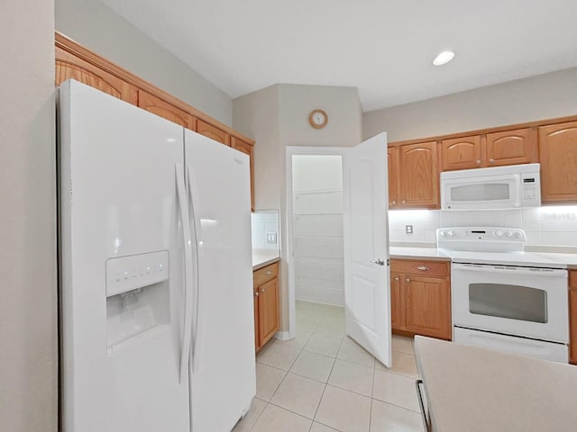 kitchen featuring white appliances, light countertops, and tasteful backsplash