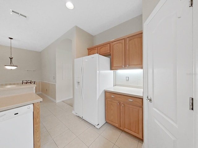 kitchen with visible vents, pendant lighting, light countertops, light tile patterned floors, and white appliances