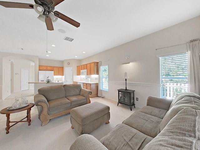 living room featuring recessed lighting, a ceiling fan, visible vents, and light carpet