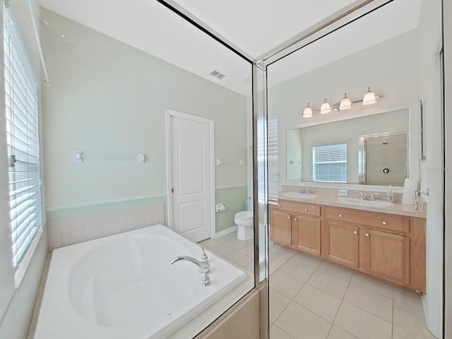 full bathroom with visible vents, toilet, a sink, a shower stall, and tile patterned flooring