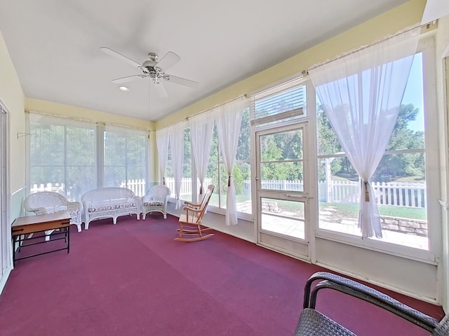 sunroom / solarium with a ceiling fan