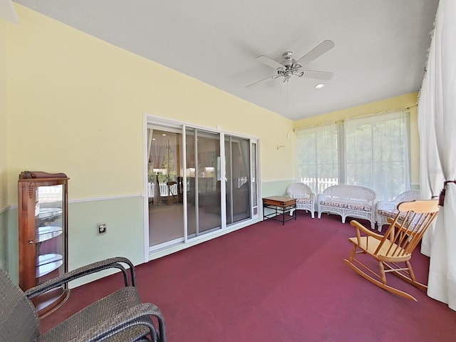 sunroom / solarium featuring a ceiling fan