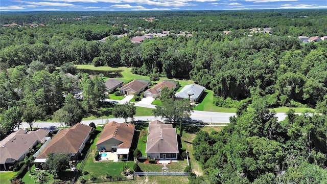 birds eye view of property with a residential view and a wooded view