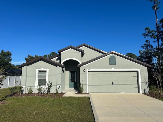 view of front of house featuring a garage and a front yard