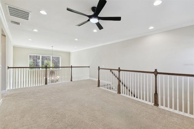 carpeted spare room featuring ornamental molding